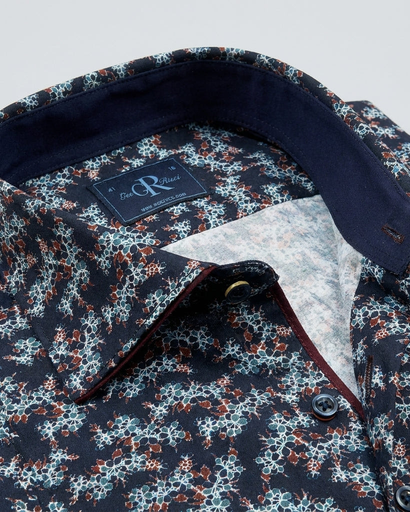 Floral patterned shirt with a brand label on a light gray background