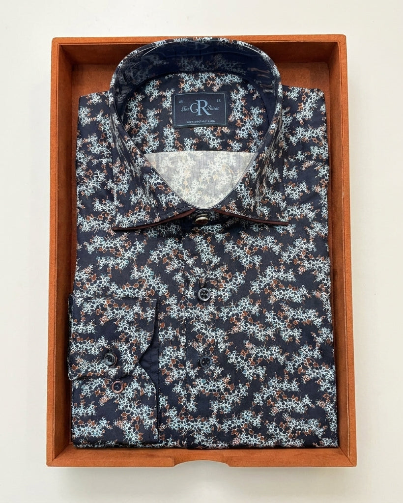Floral patterned shirt in a wooden box on a light background