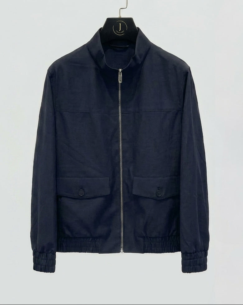 Navy jacket on a hanger against a light gray background
