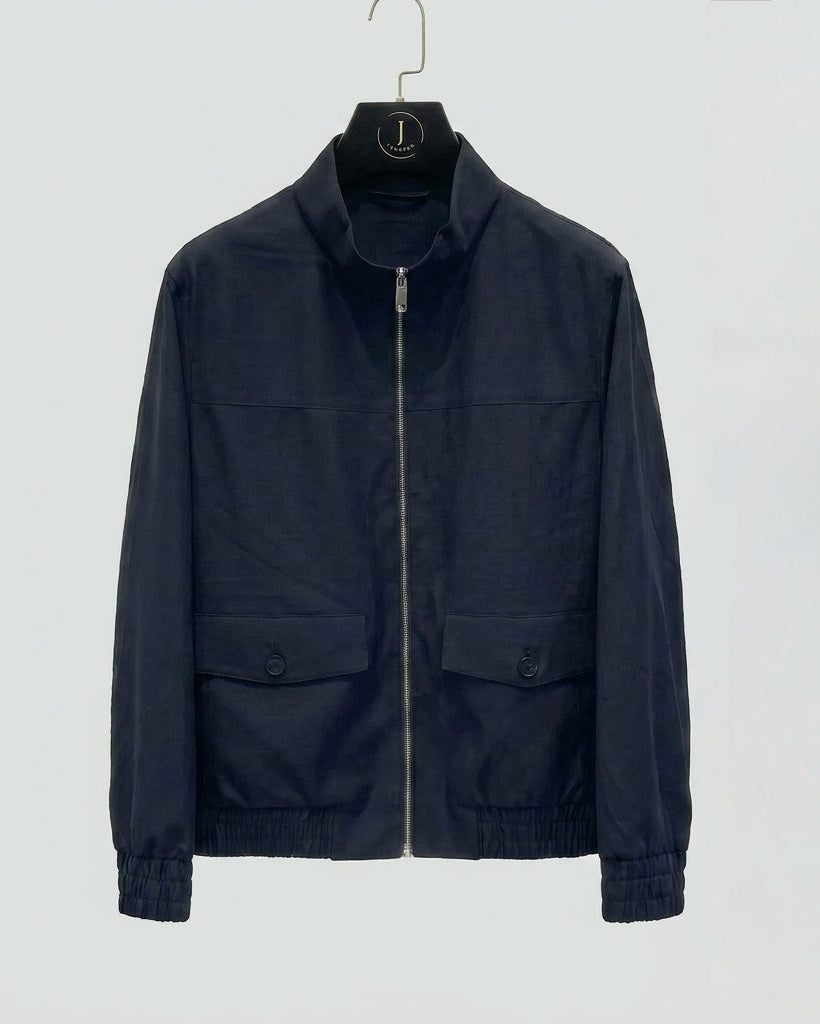 Navy jacket on a hanger against a white background