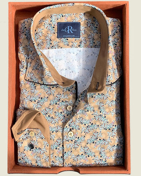 A long-sleeved camel floral shirt with a contrast collar, displayed in an open box.