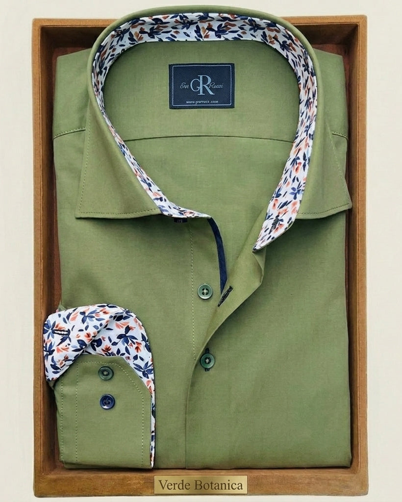 Green shirt with floral collar in a wooden box on a beige background