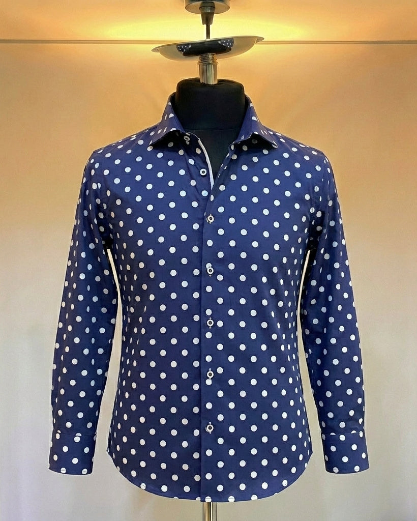 Blue shirt with white polka dots on a mannequin against a neutral background