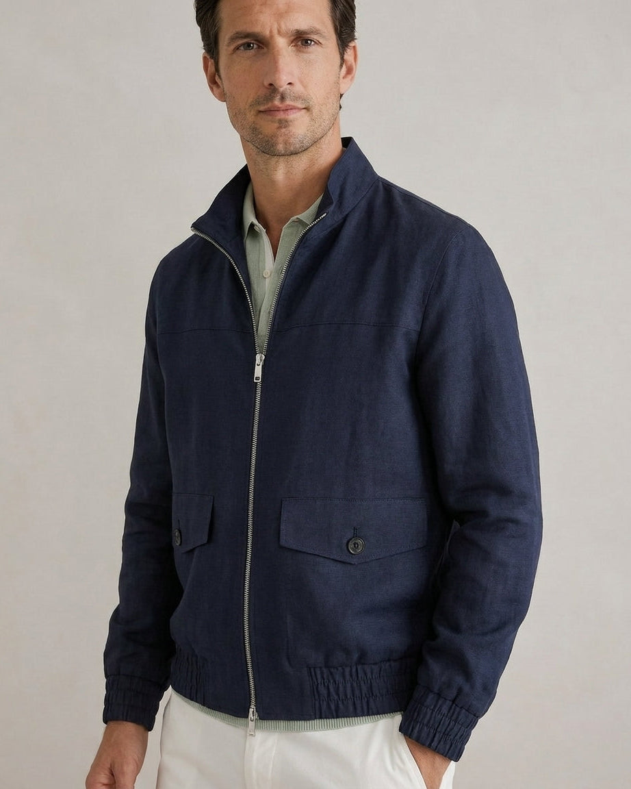 Man wearing a navy blue jacket on a plain background