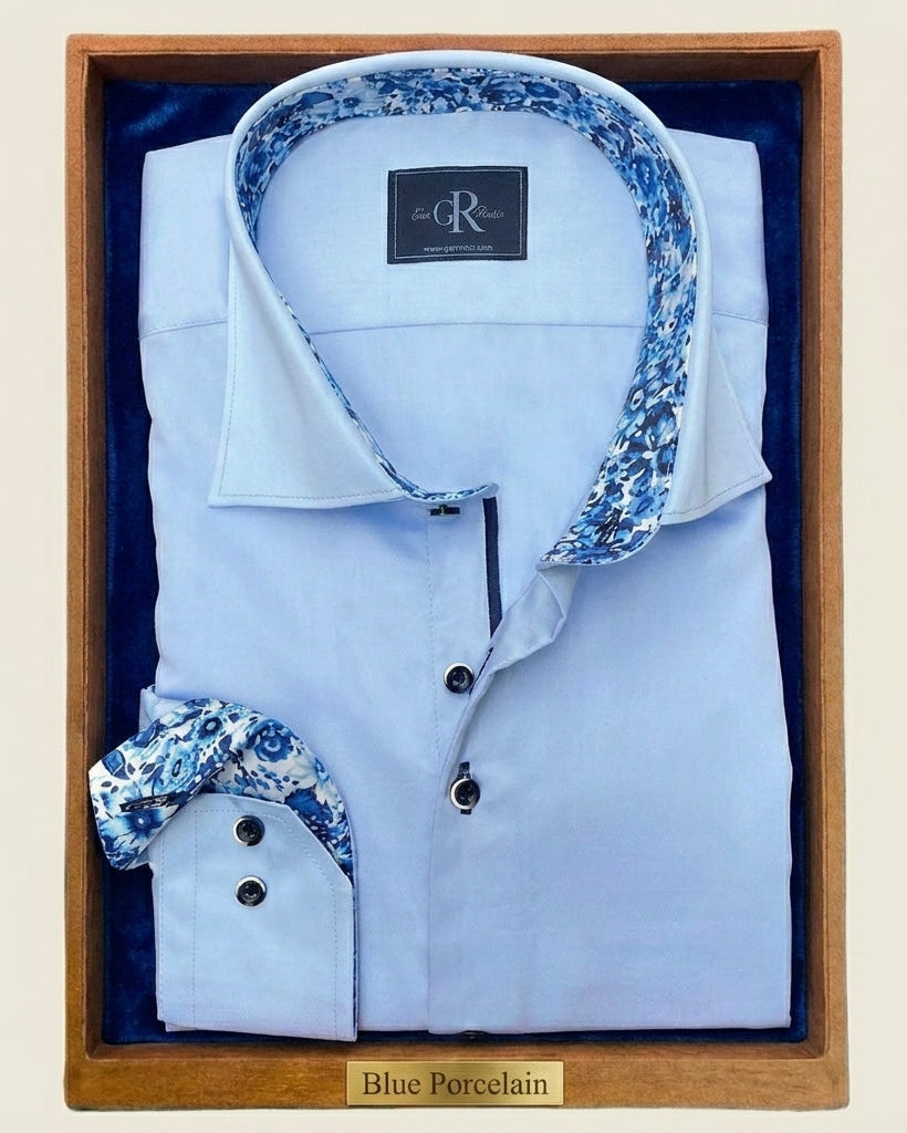 Light blue dress shirt with floral cuffs and collar in a wooden box.