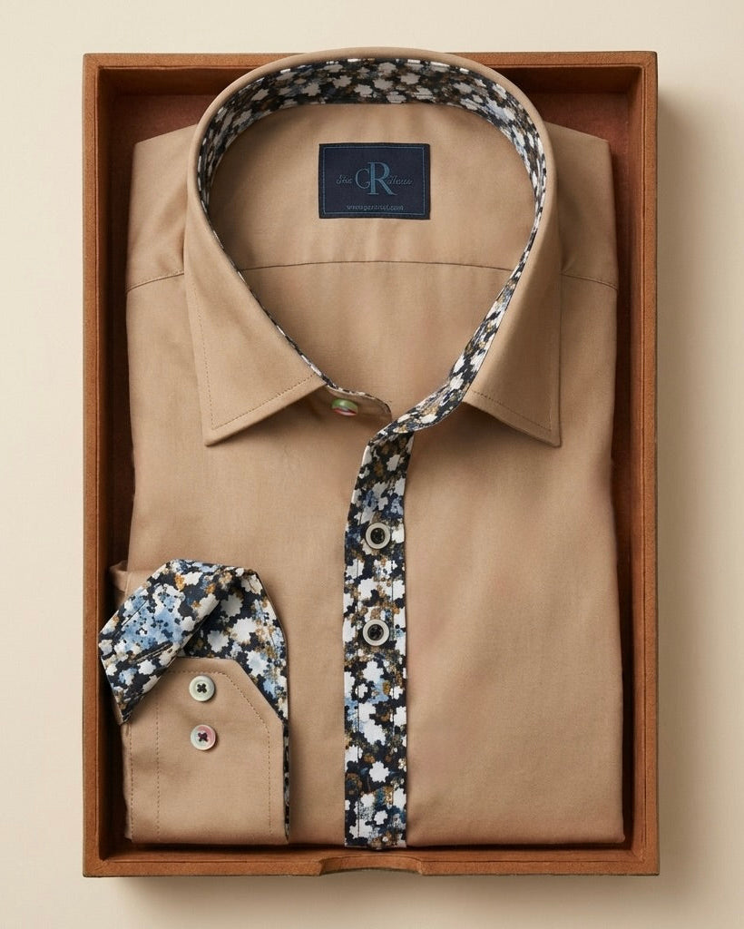 Beige shirt with floral trim in a wooden box on a beige background