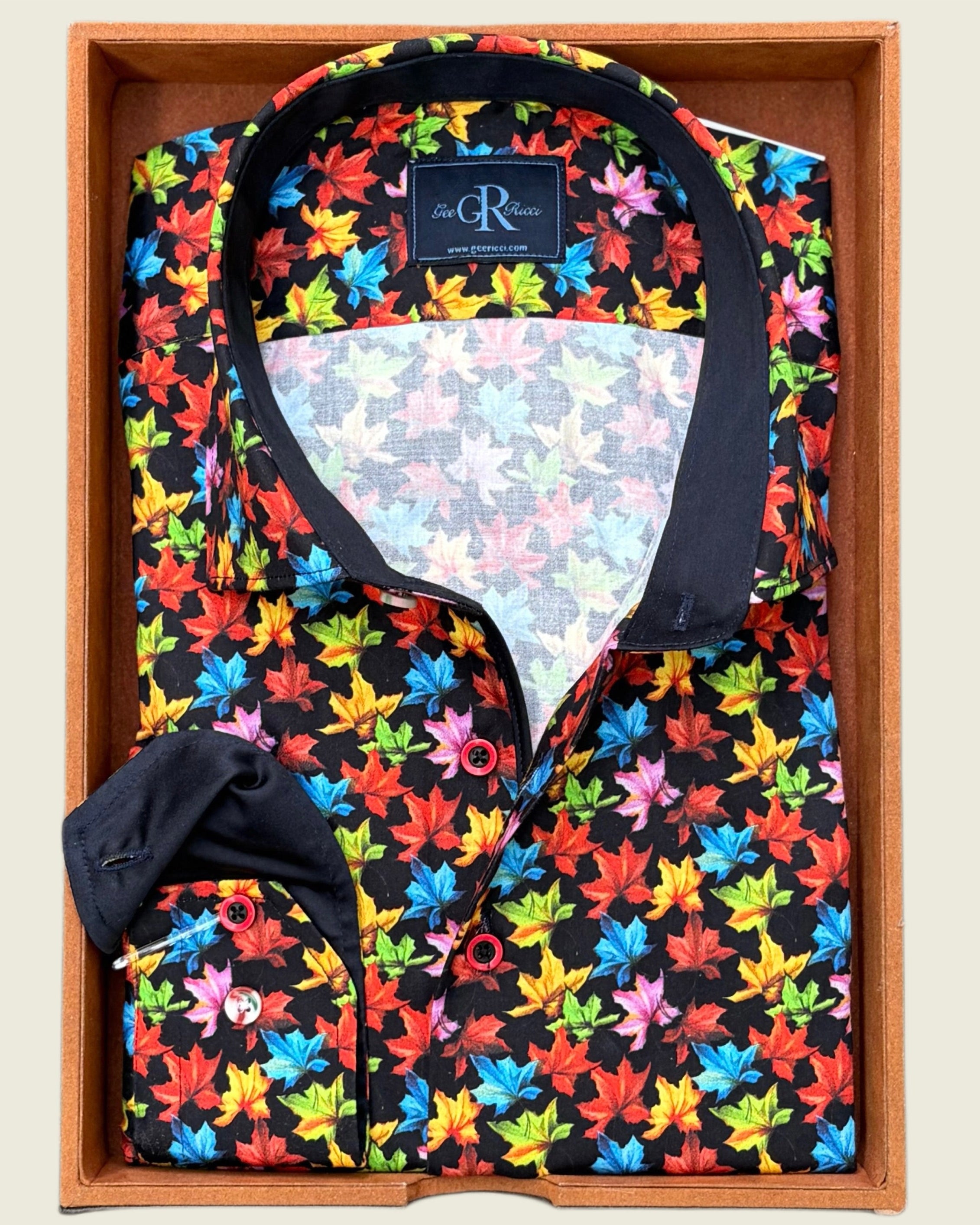 Colorful floral-patterned shirt with black collar and bow tie in a wooden box.