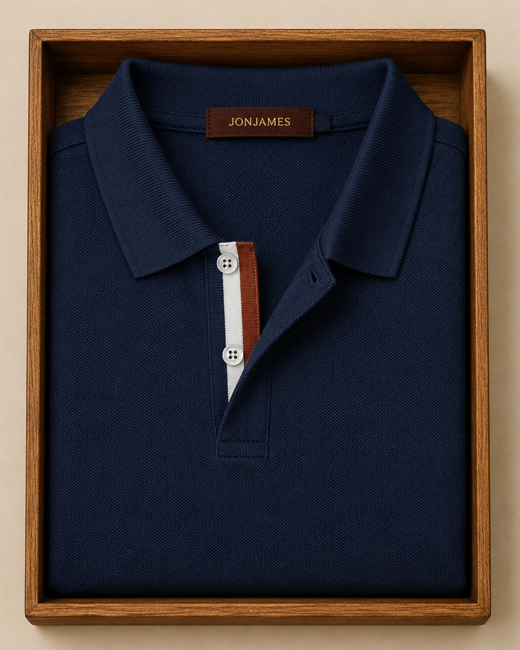 Navy blue polo shirt with buttons in a wooden box, featuring the Jon James brand.