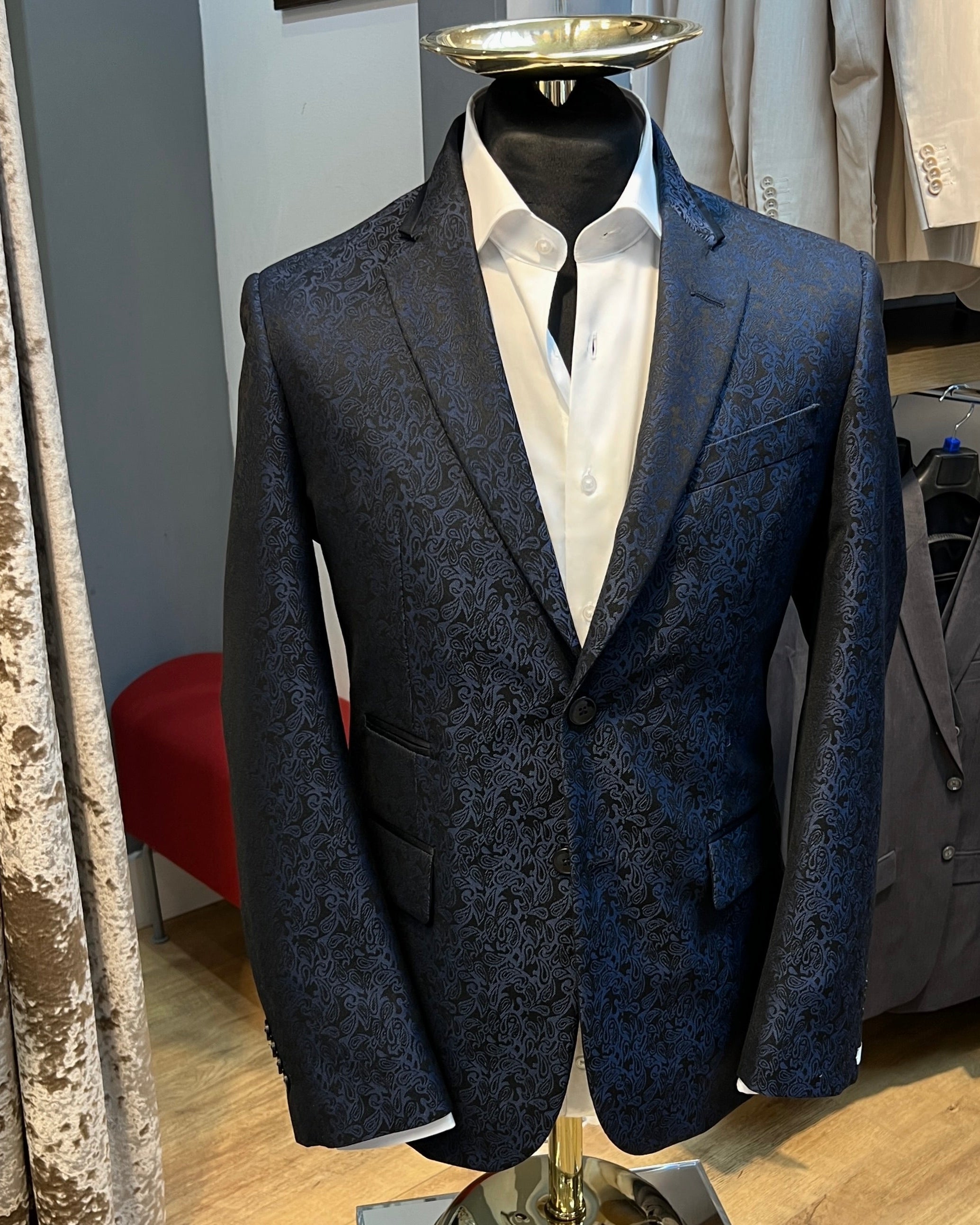 Blue pasiley blazer on a mannequin in a store setting
