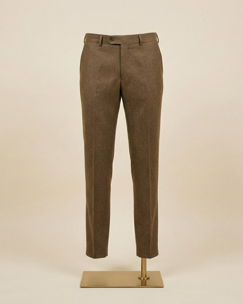 Brown pants on a mannequin stand against a beige background