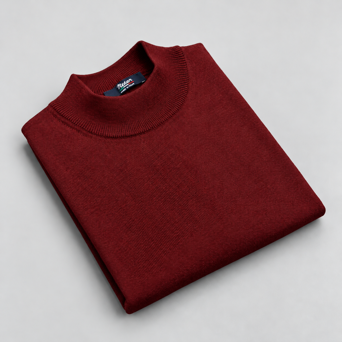 burgundy merino wool mock neck folded on a pale grey background
