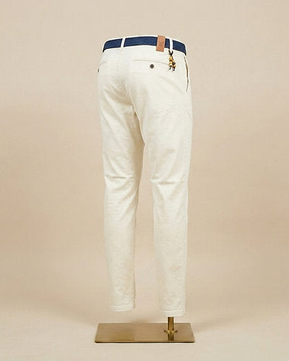 White pants with a blue belt on a mannequin against a beige background