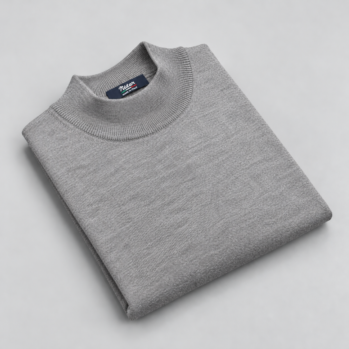 light grey merino wool mock neck folded on a pale grey background