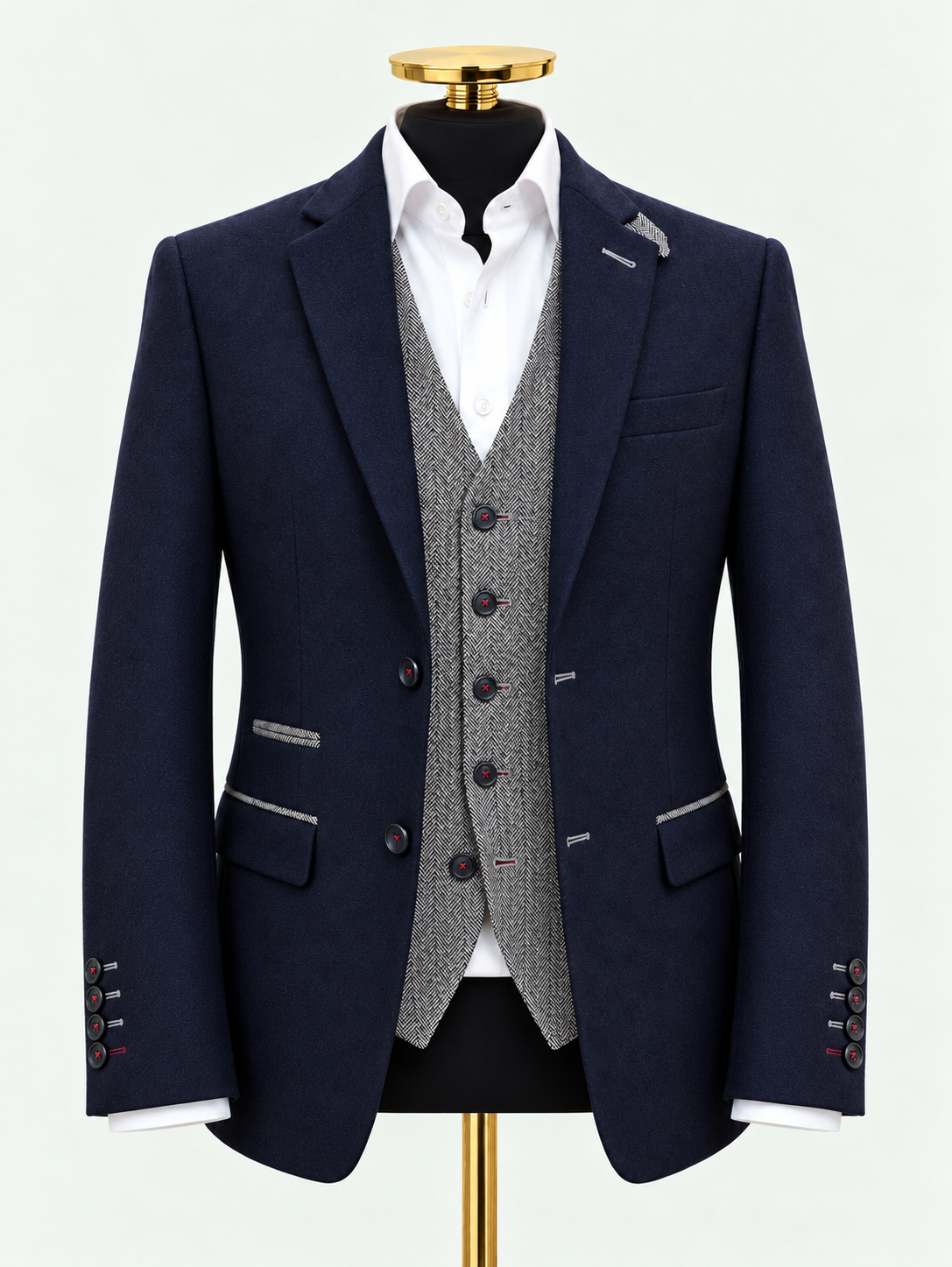 Updated midnight navy blazer with grey herringbone trim and waistcoat on a black mannequin against pale grey