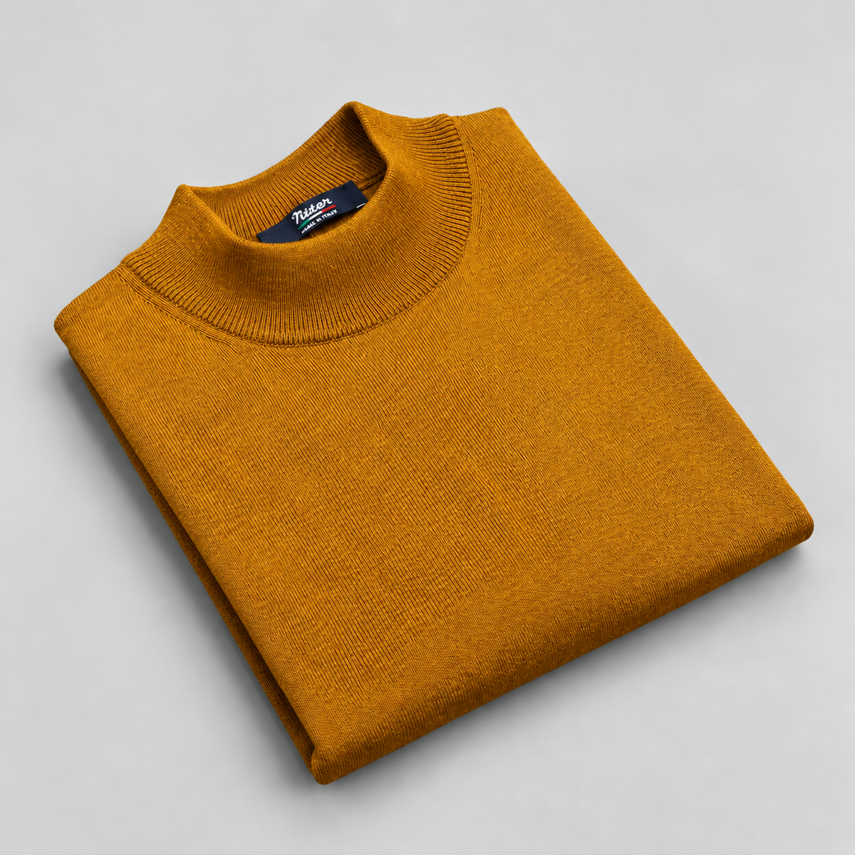 mustard merino wool mock neck folded on a pale grey background