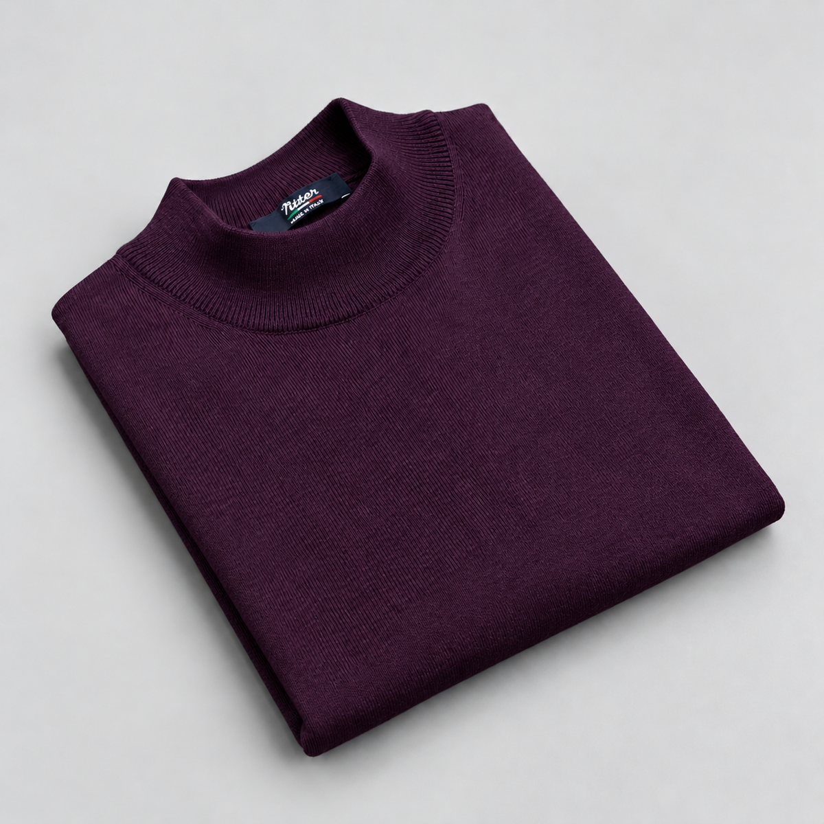 violet merino wool mock neck folded on a pale grey background