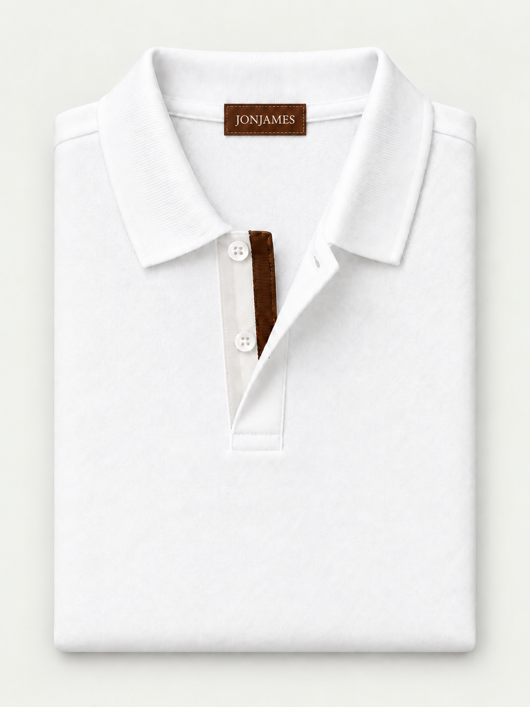 White Piqué Polo - Short Sleeve - Regular Fit – folded polo on pale grey background