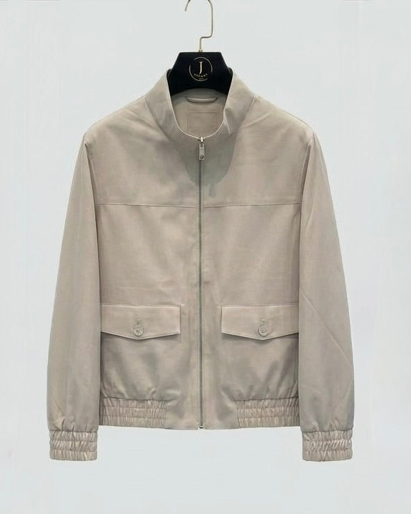 Beige jacket on a hanger against a white background