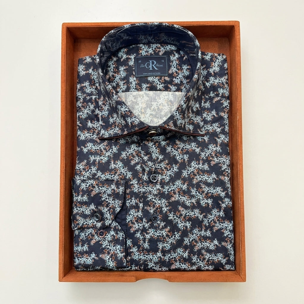 Floral patterned shirt in a wooden box on a light background