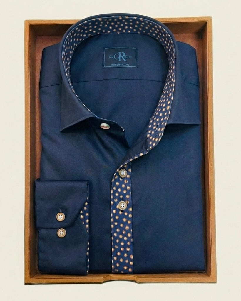 Navy blue dress shirt with patterned collar in a wooden box on a beige background