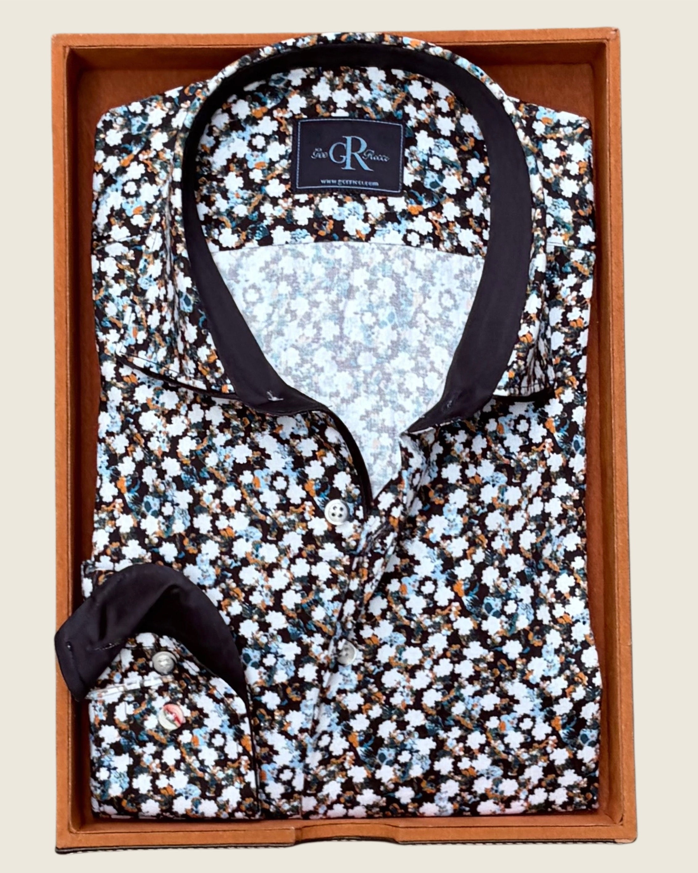 Floral-patterned shirt in a wooden box with a visible brand label.