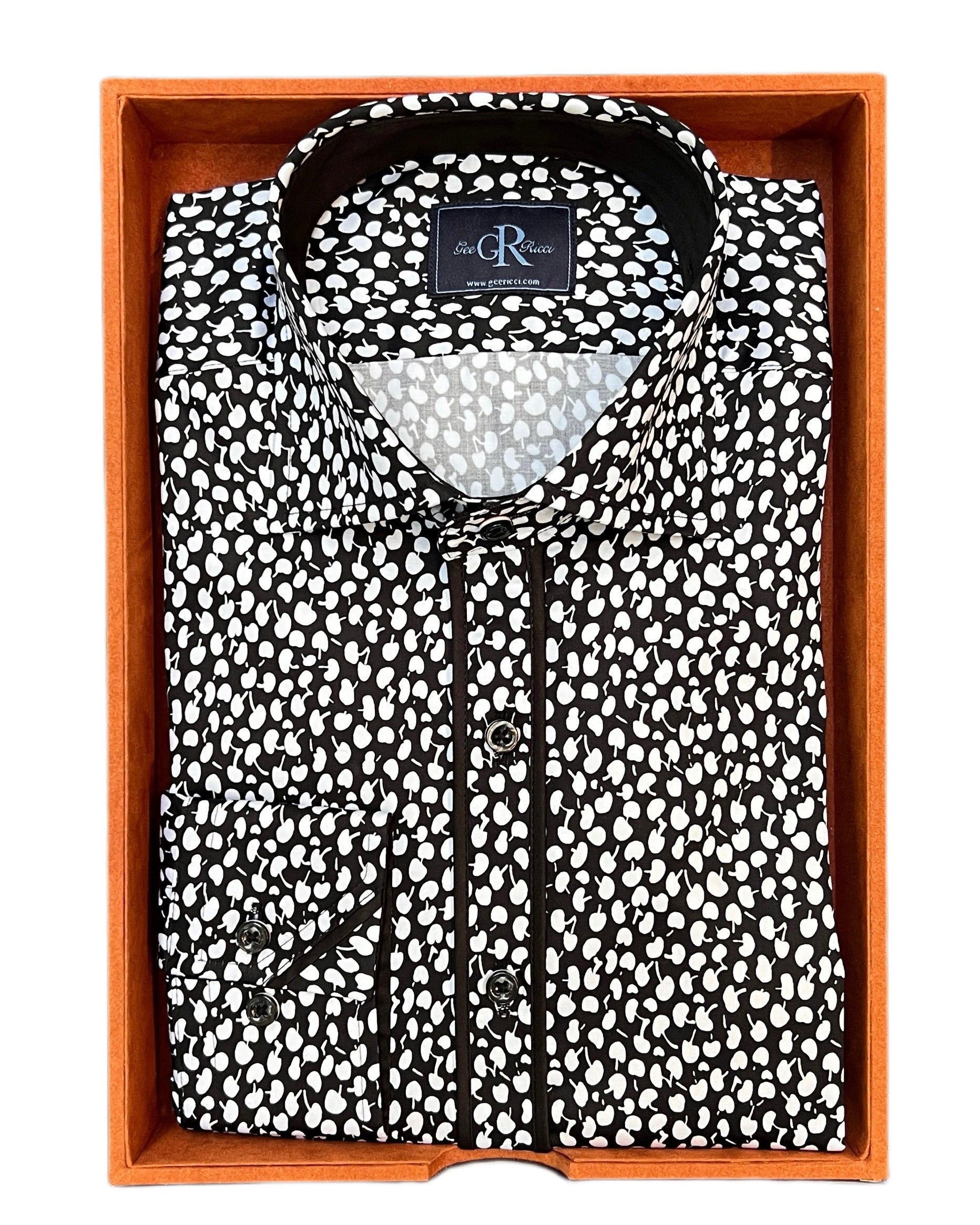 A black and white print shirt displayed in a box, with the brand tag visible.