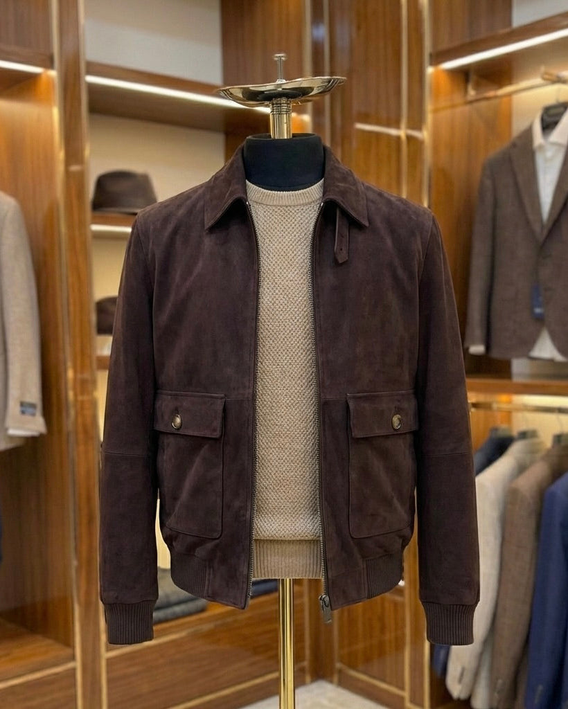 Burgundy jacket on a mannequin in a clothing store setting with other jackets and shirts in the background.