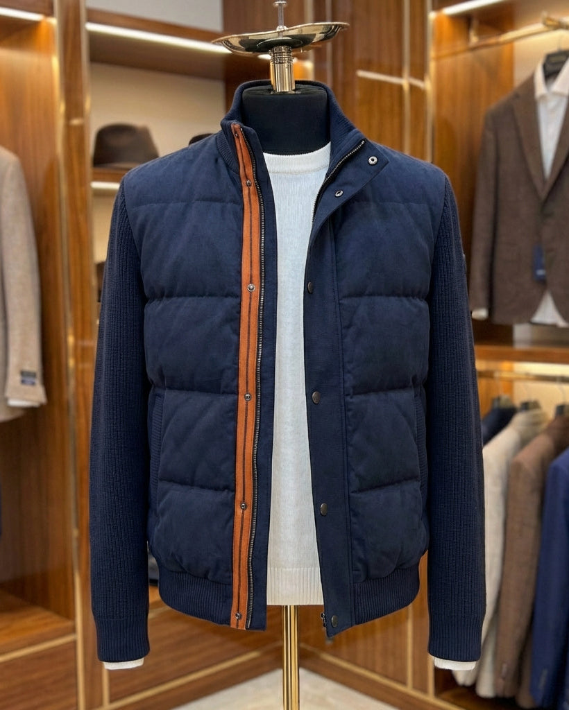 Navy puffer jacket on a mannequin in a clothing store setting