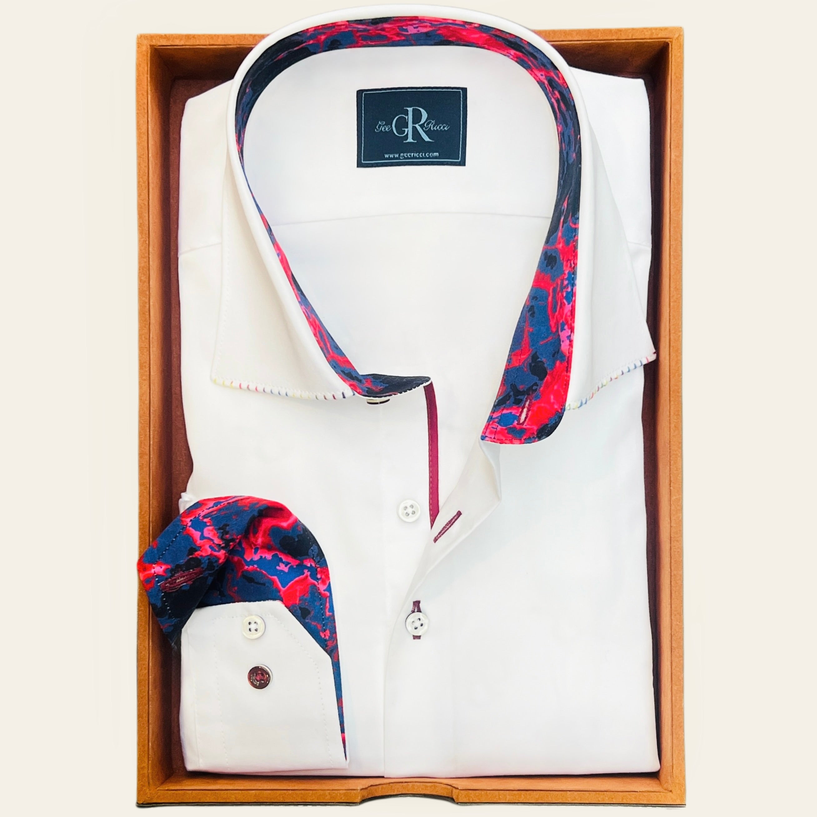 A white sateen shirt with a concealed button-down collar featuring a red and navy lava-print lining.