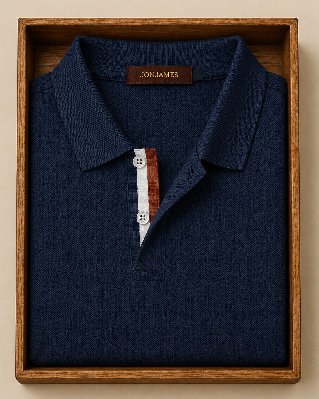 Navy blue polo shirt with buttons in a wooden box, featuring the Jon James brand.