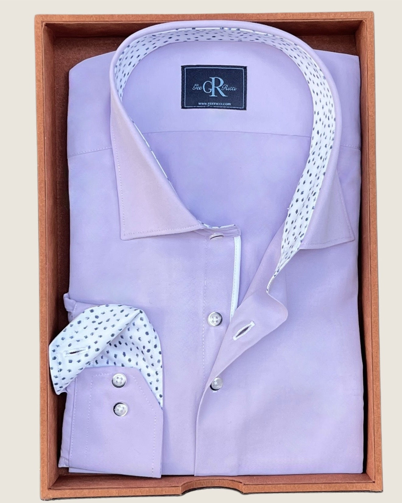 Lavender dress shirt with white collar and cuffs in a wooden box, featuring a visible brand label.