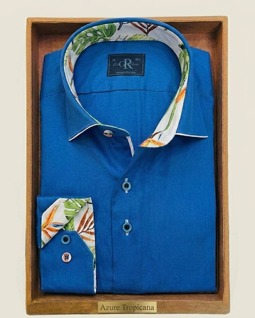 Blue shirt with floral collar and cuffs in a wooden box on a beige background
