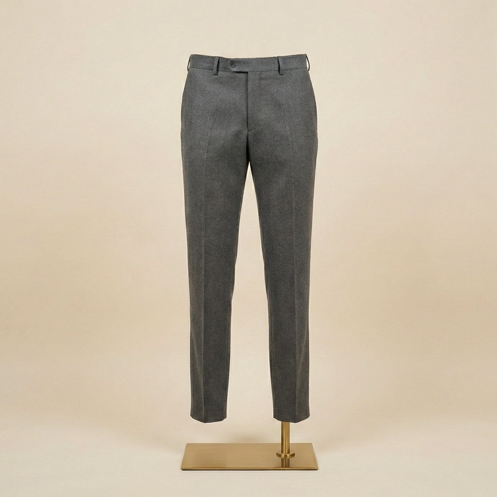 Gray pants on a mannequin stand against a beige background
