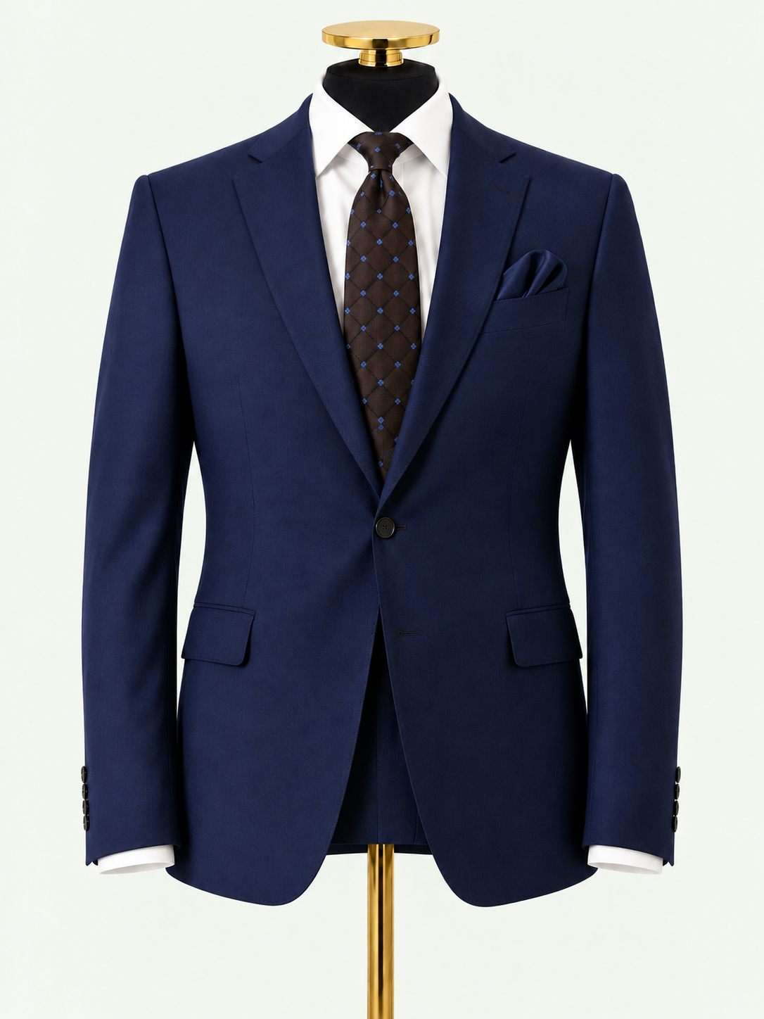 The Regent Navy Wool Blend 2-Piece Suit on a gold mannequin against pale grey